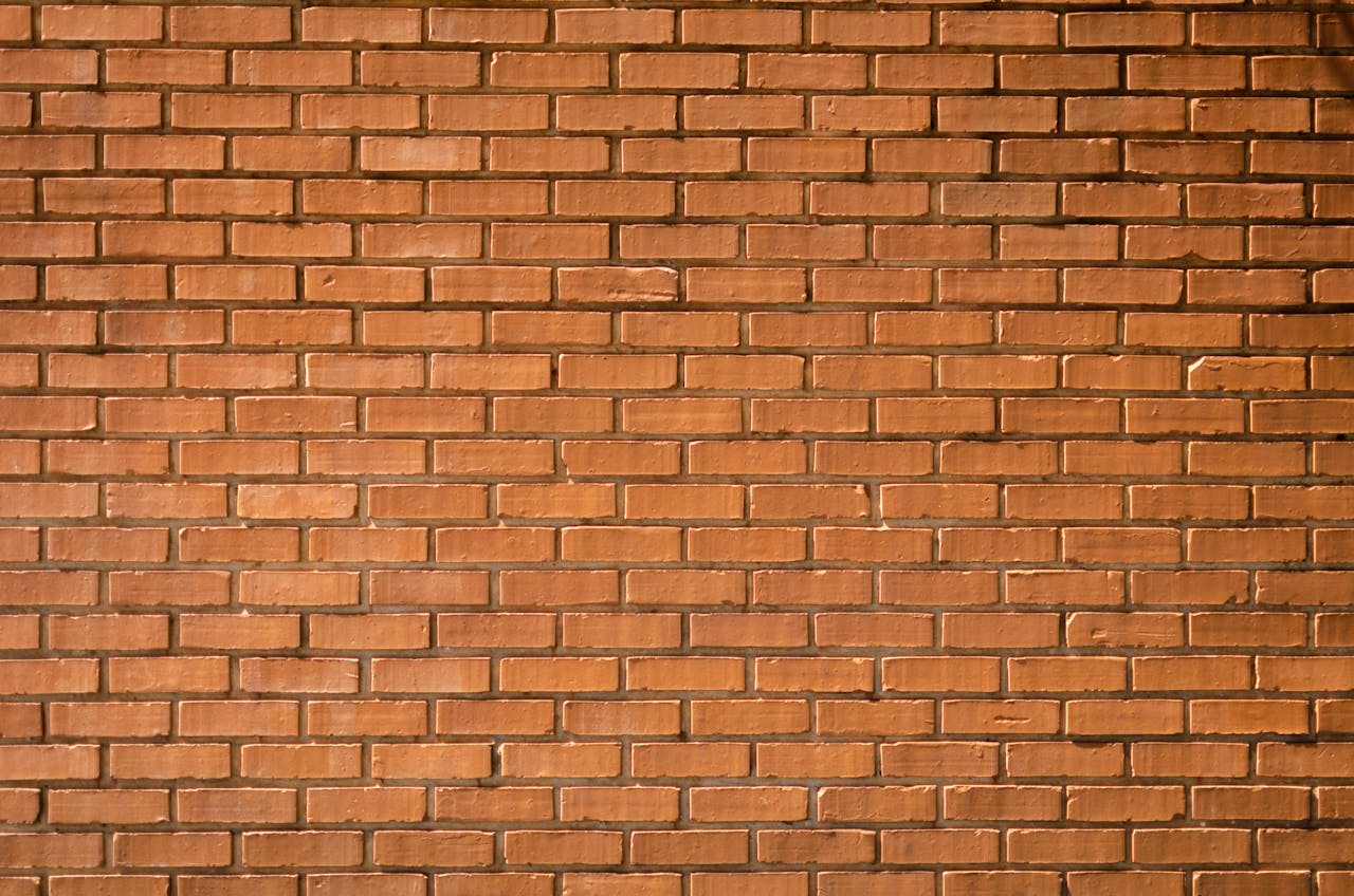 Close-up of a red brick wall showcasing natural texture and pattern.
